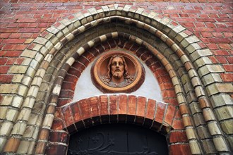 Depiction of Jesus above a side entrance