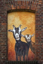 Mural of goats on the facade of a goat cheese dairy