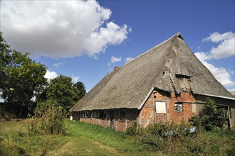 Old farmhouse with low thatched roof