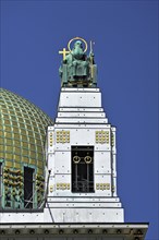 Statue of the preacher Severin beside the dome of the Church of St. Leopold at Steinhof Psychiatric Hospital