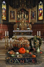 Thanksgiving decoration in front of the polyptych altar in the neo-Gothic Parish Church of St. Pelagius