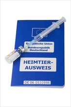 A syringe and a vial on an EU pet passport