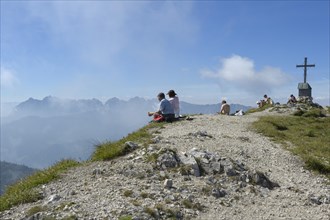 Hikers on the summit of Geigelstein Mountain