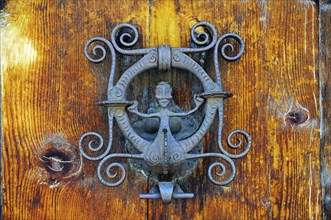 Wrought-iron door knocker with a figure