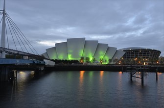 Illuminated Clyde Auditorium with the Bell Bridge and The Hydro arena on the River Clyde