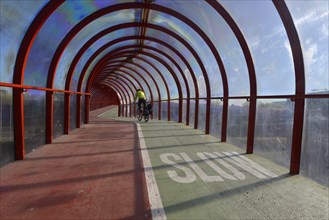 Cyclist is riding on a Scottish Exhibition and Conference Centre Footbridge