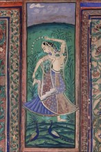 Dancing woman with two peacocks