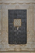Iron door framed by ornate columns