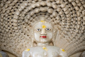 Head of Tirthankar Parshvanat in the medallion protected by the thousand-headed serpent God Dharanendra against a powerful storm
