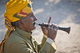 Flute player wearing a yellow turban
