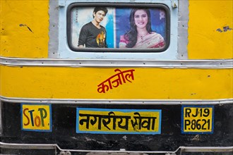 Rear of a motorised rickshaw with images of the Bollywood stars Sharukh Khan and Khajol