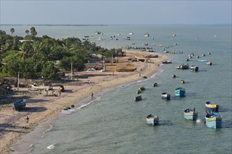 Fishing boats and fishermen's huts on the beach