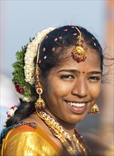 Smiling bride with jasmine flowers in her hair
