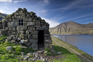 Old stone house on a fjord