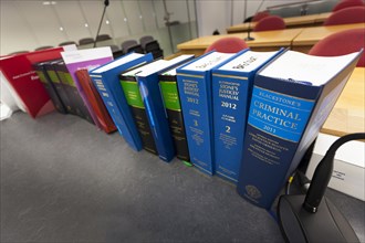 Row of law books focused on Blackstones Criminal Practice and Butterworths Stone's Justices' Manual in court room