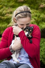 Young woman cuddling a Jack Russell puppy