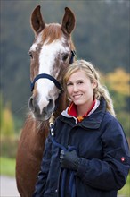 Young woman with an Austrian Warmblood