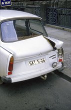 Cracked trunk lid of a white Trabant