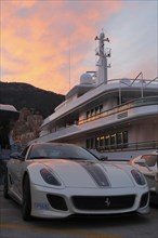 Ferrari in front of the motoryacht 'Siran' in Port Hercule at twilight