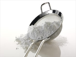 Powdered sugar in a sieve