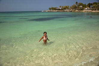 Little Cuban girl on Playa Bacuranao beach
