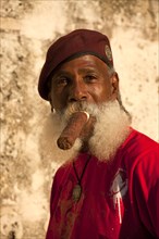 Man with a beard smoking a cigar