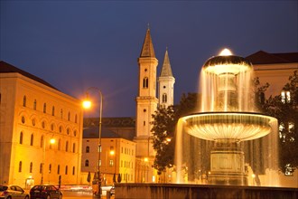 Illuminated fountain of the University and the Church of St. Louis