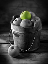 Granny Smith apples in a wooden bucket