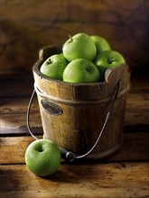 Granny Smith apples in a wooden bucket
