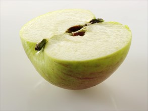 Freshly cut half of a Bramley apple
