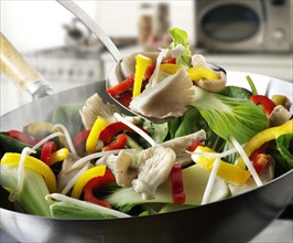 Stir-fry vegetables in a wok