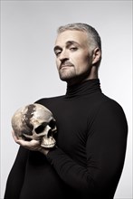 Man holding a skull