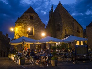 Visitors to the Brasserie Le Medieval dining outdoors