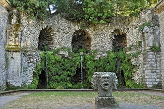 Stone mask with four heads at the grotto of the water source