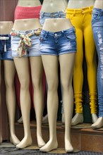 Legs of mannequins with jeans and hot pants