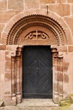 Medieval sandstone relief above the entrance door to the chapel