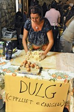 Woman making cake dough during a town festival
