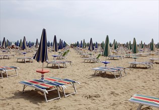 Deck chairs and parasols on the beach of Lignano