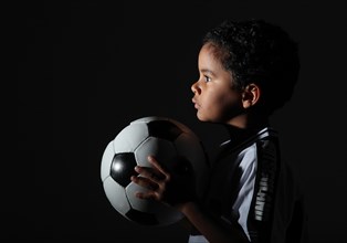Boy in a jersey holding a football
