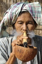 Old woman smoking a cheroot cigar