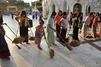Women sweeping the floor as a ritual action