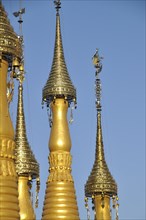 Gold-coloured stupas with golden hti