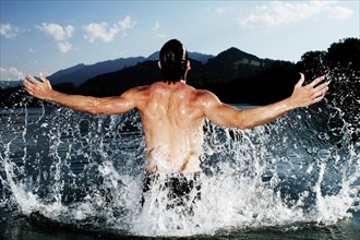 Man splashing about in a lake in Sonthofen