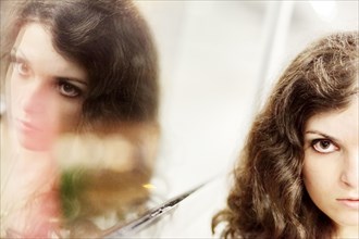 Woman and her mirror image