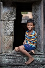 Boy in the temple complex of Preah Khan or Prah Khan