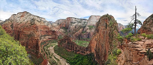 Panoramic view of Zion Canyon the Angels Landing rock formation with sheer cliffs on either side