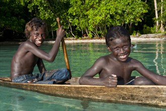 Local boys in a canoe in the Marovo Lagoon