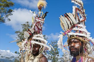Members of a tribe in colourfully decorated costumes with face paint at the traditional sing-sing gathering