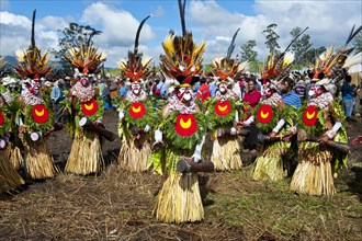 Members of a tribe in colourfully decorated costumes with face paint at the traditional sing-sing gathering