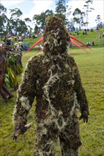 Man covered in moss at the traditional sing-sing gathering